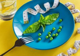 Diet blue plate with centimeter peas and basil