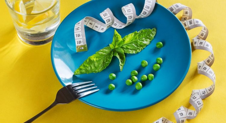 Diet blue plate with centimeter peas and basil